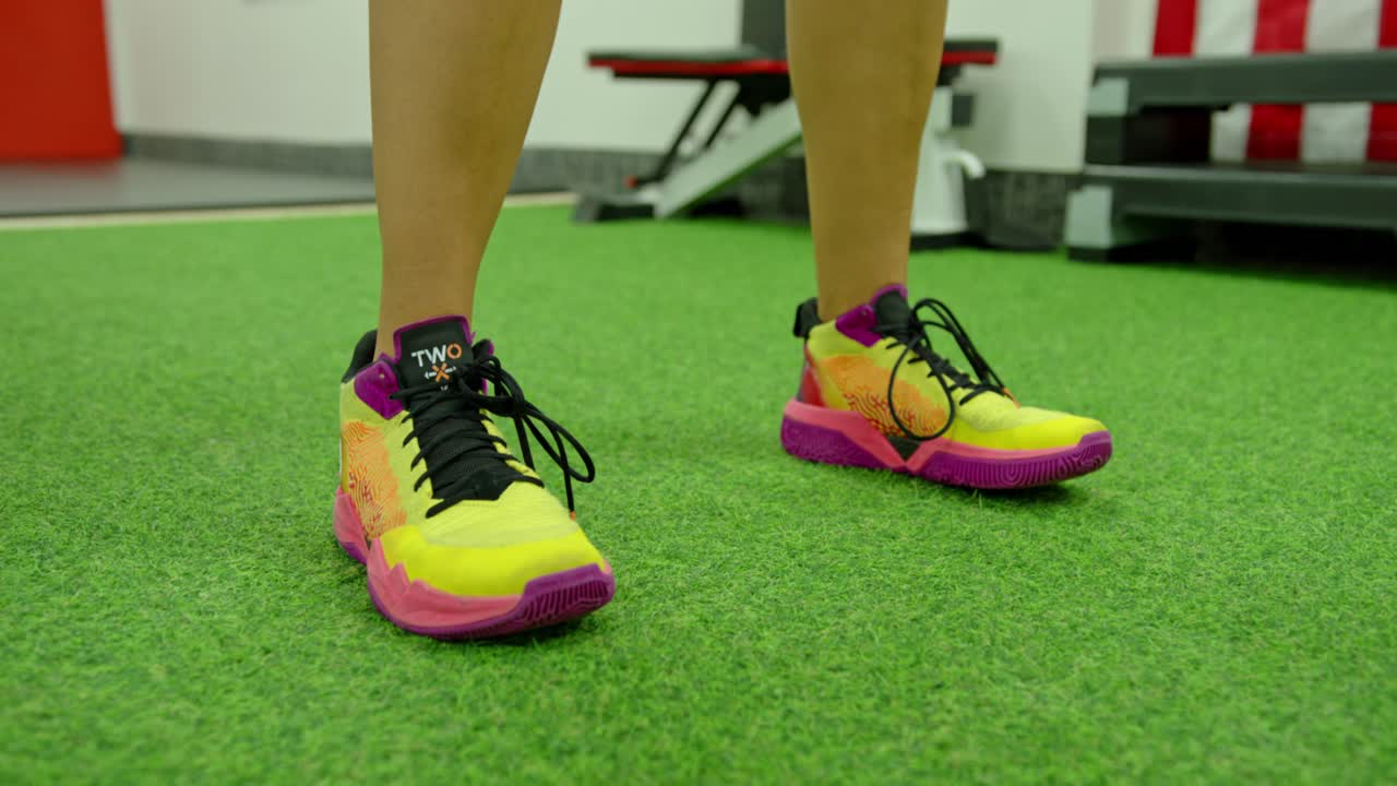 Muscular woman working out in the gym lifting weights