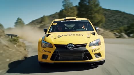 yellow rally car on winding mountain road