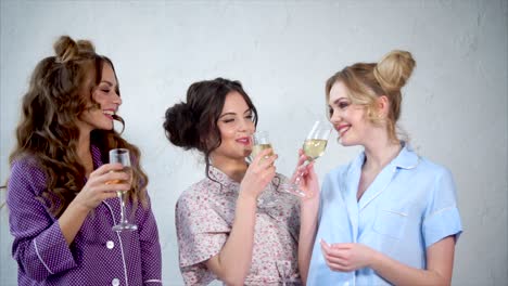 friends celebrating with champagne in pajamas