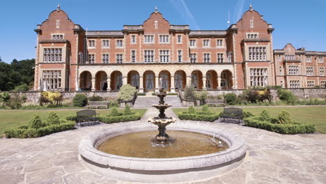 Wide-shot-of-an-English-Mansion-with-a-running-fountain-in-the-foreground