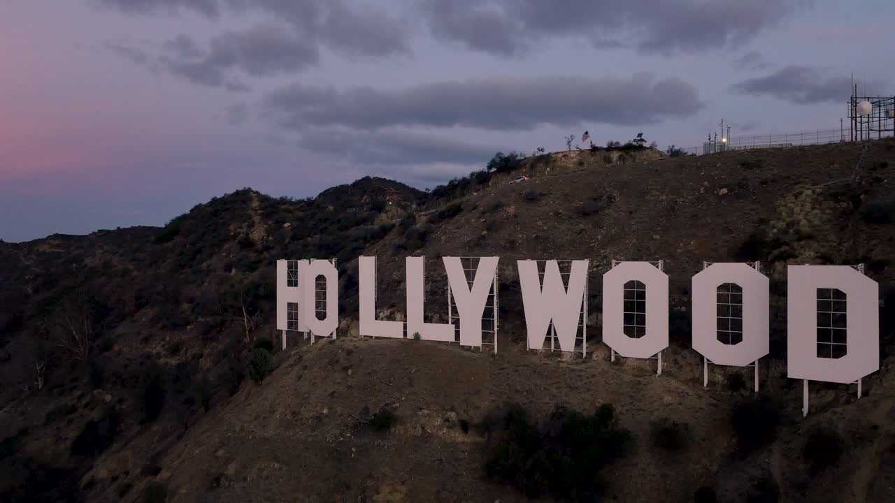 The iconic Hollywood Sign on a hillside at dusk