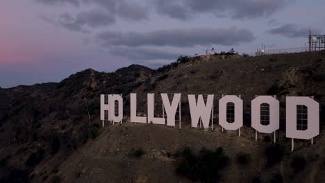 the iconic hollywood sign on a hillside at dusk