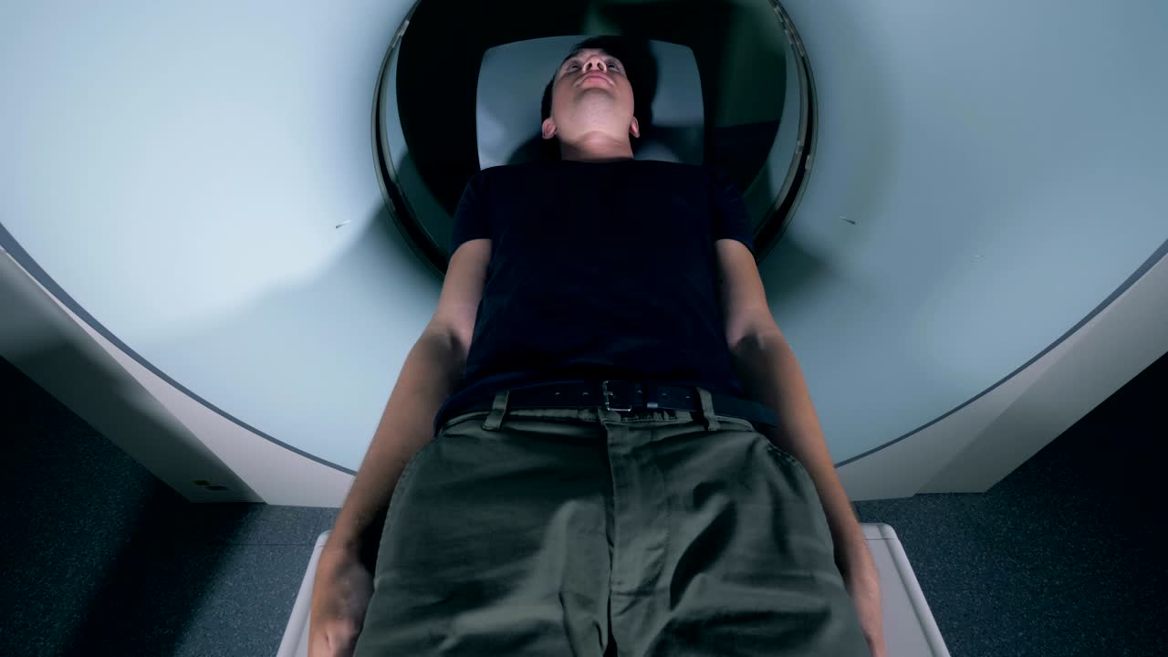 Male patient is coming out from an MRI scanning mechanism