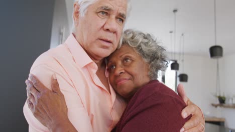 Happy-senior-diverse-couple-dancing-in-kitchen-at-retirement-home