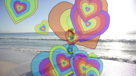 animación de corazones coloridos sobre mujer biracial caminando por la playa