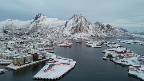 a snowy coastal village with mountains in svinøya, featuring scenic winter views