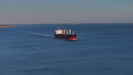 Middle-of-the-ocean-a-large-vessel-transporting-shipment-onwards,-aerial