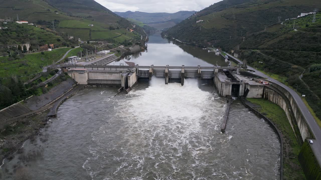 Regua Dam spillway in action on Douro river, Portugal - aerial