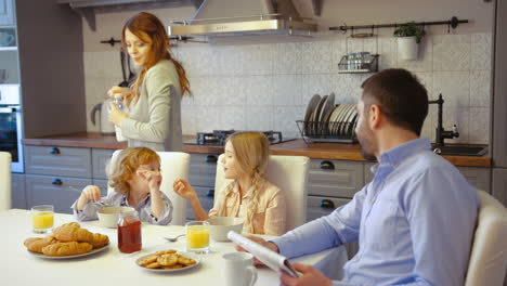 family having breakfast in the kitchen