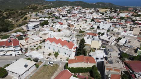 Aerial-orbit-around-white-Greece-orthodox-church-in-city-Embonas,-Rhodes