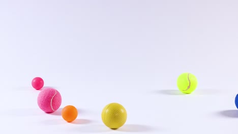 various balls moving across a white background