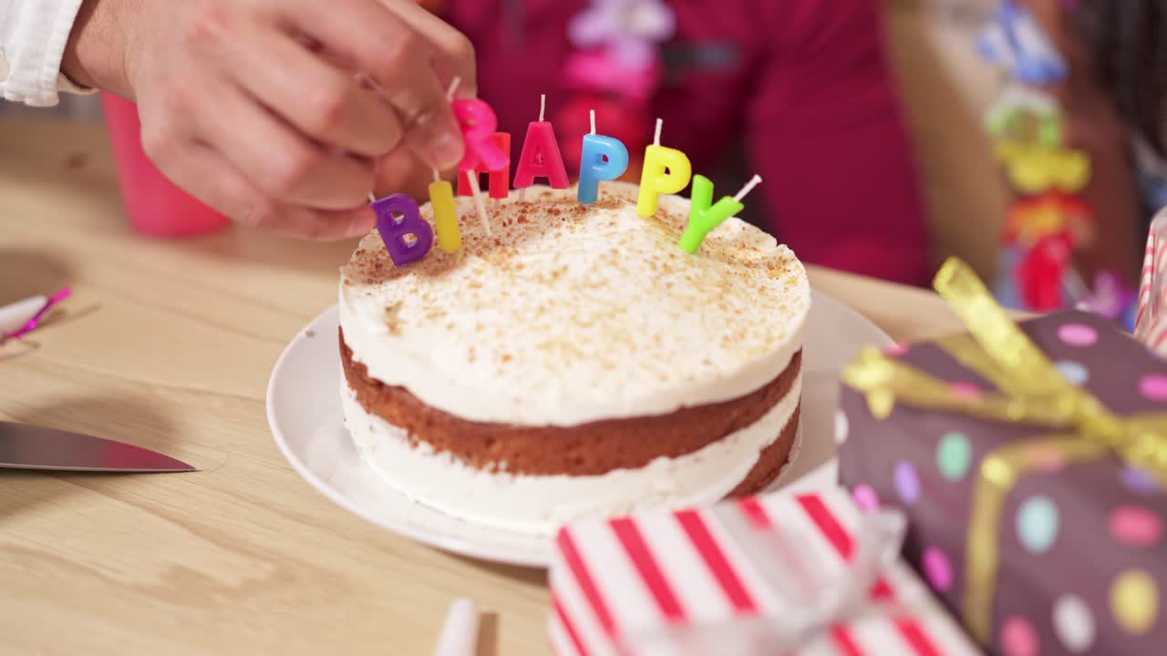 Decorating a birthday cake with candles at a party
