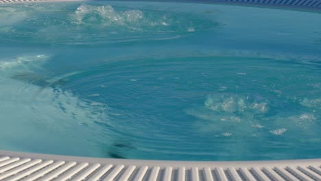 Commercial-hot-tub-Starting-off-with-calm-water-and-then-having-air-blown-though-the-waterCommercial-hot-tub,-Hottub,-Calm-water,-air-blown,-water,-Bubbles,-Fhv