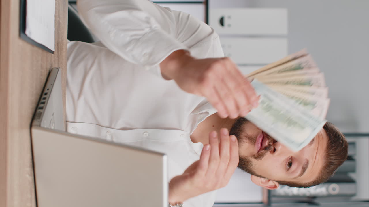 Young business man showing money dollar cash gives to you wages salary satisfied with good work