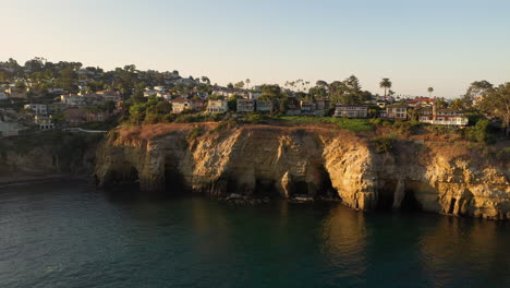 scenic view of la jolla sea caves in san diego, california on a sunset - wide drone shot