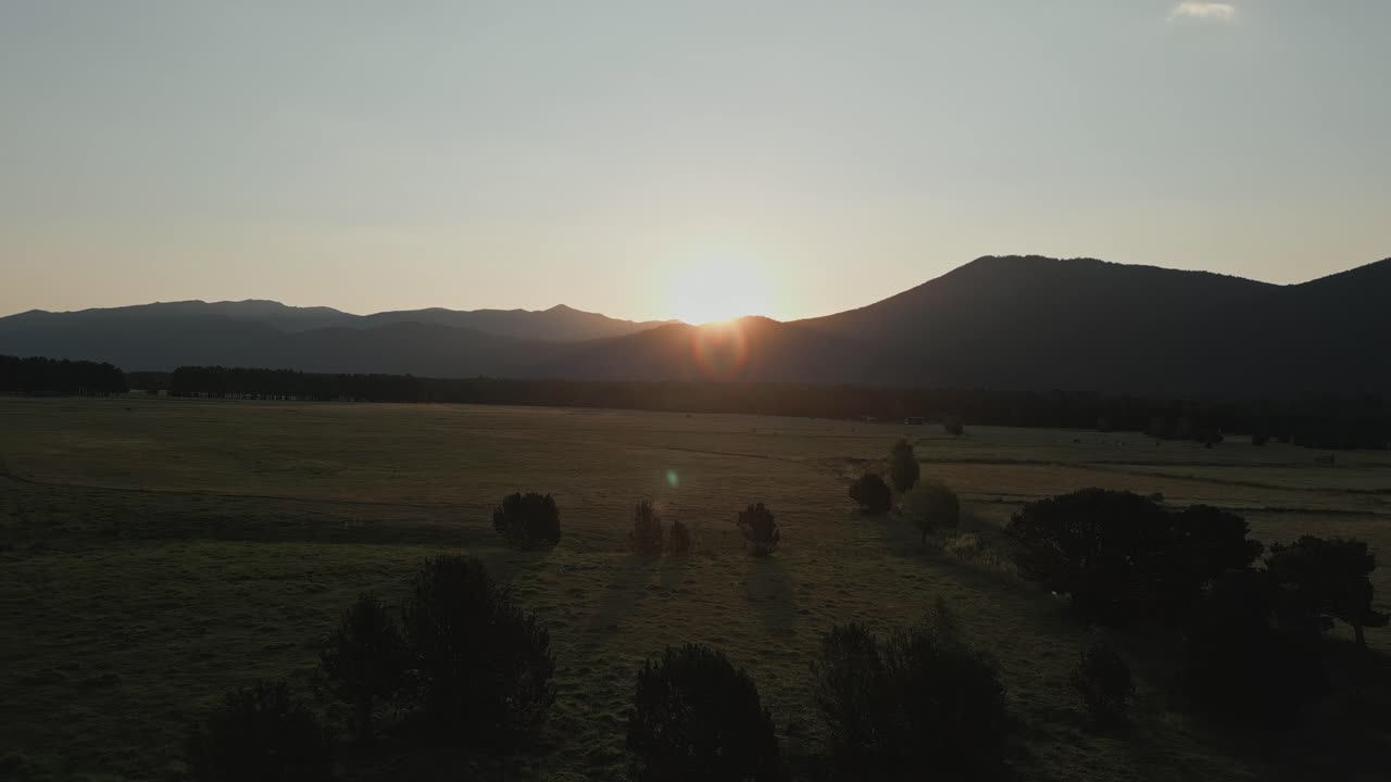 Sunset over Mountains and Fields