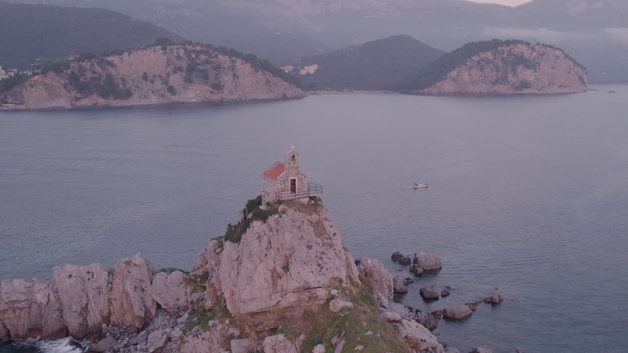 Drone flying close over famous Nedjelja Church on rock during sunset, aerial