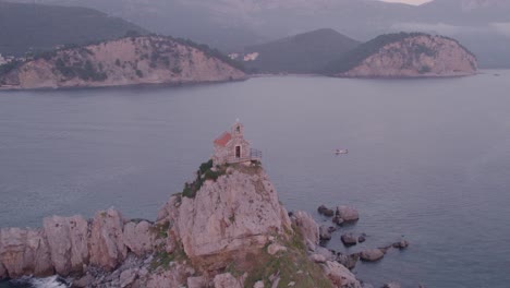 drone flying close over famous nedjelja church on rock during sunset, aerial