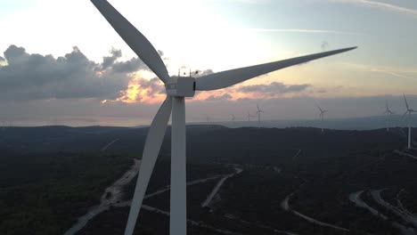 empuje aéreo lento en la cabeza de una turbina eólica con un hermoso fondo de puesta de sol