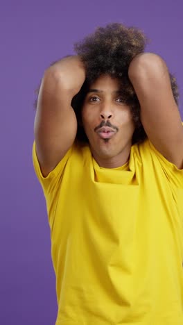 man with afro and mustache making funny expressions