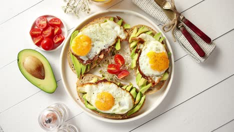 delicious healthy breakfast with sliced avocado sandwiches with fried egg