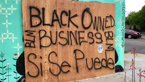 a boarded up los angeles storefront is identified as a black owned business during rioting and looting black lives matter protests