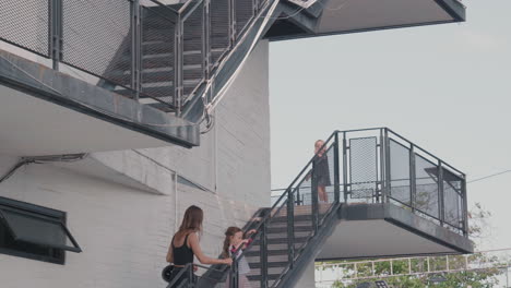 woman and kids going upstairs