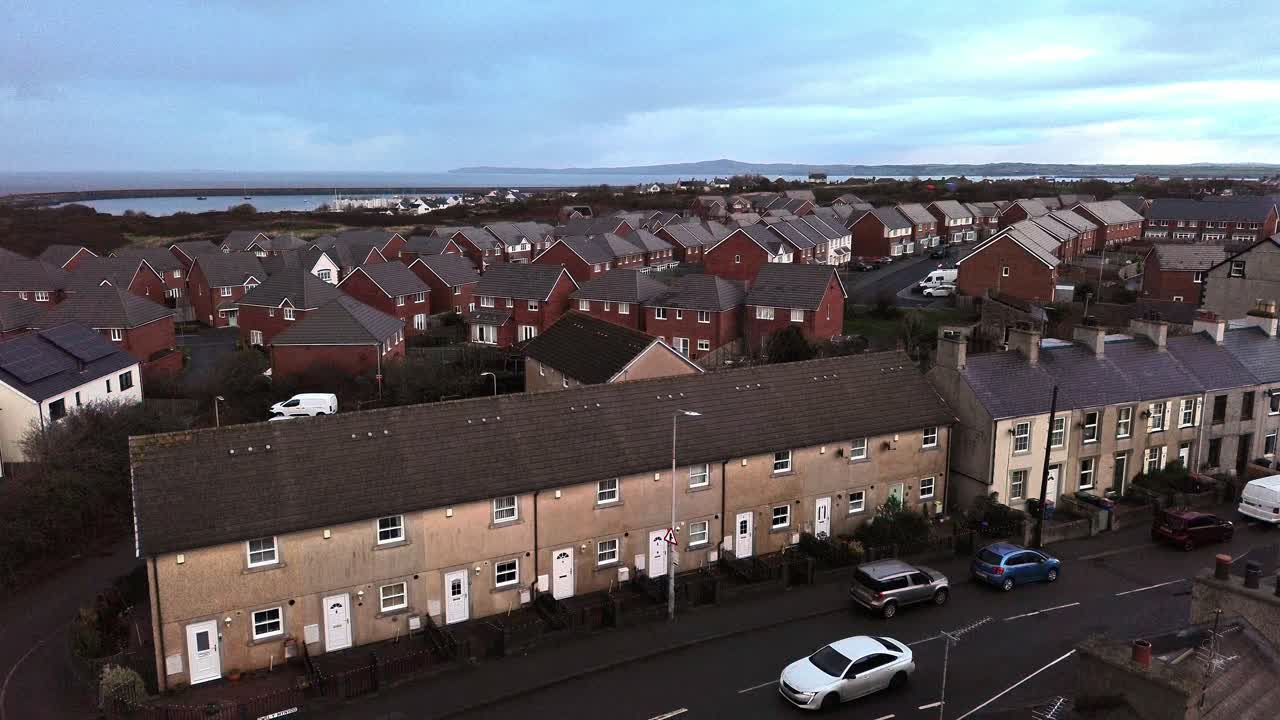 Holyhead town aerial view descending over old terraced property and new red brick build homes