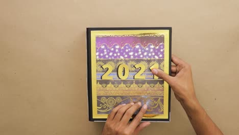 Gluing-golden-numbers-on-cover-of-year-2021-scrapbook-lever-arch-file