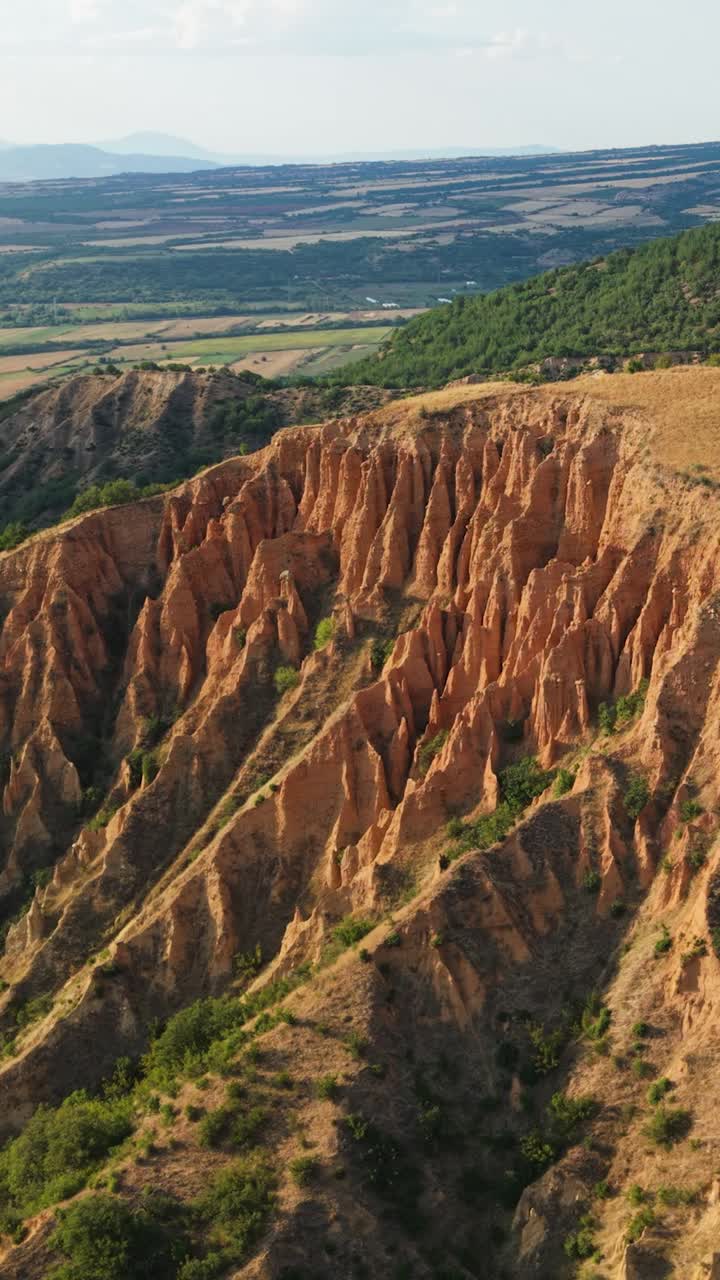 Cinematic aerial shot highlights the dramatic sandstone towers of the Stob Pyramids Bulgaria with scenic mountain and valley views