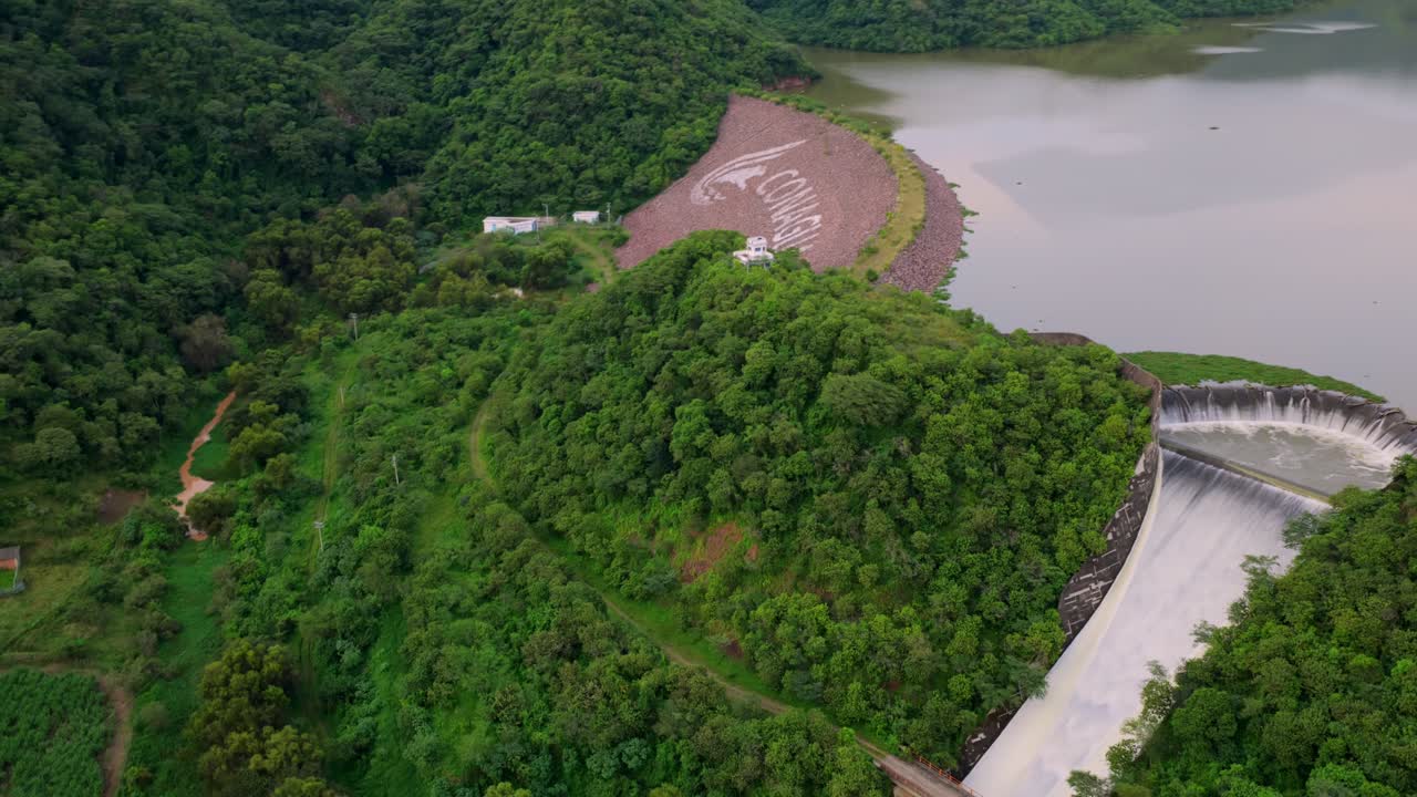 Drone footage of Presa EL Carrizo, Tamazula de Gordiano, Jalisco. Captivating landscape with lush greenery, flowing water, and vibrant colors under soft, natural lighting