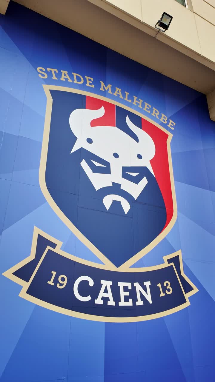 Vertical still views to the Caen Malherbe Stadium sign above the entrance, Caen, France.