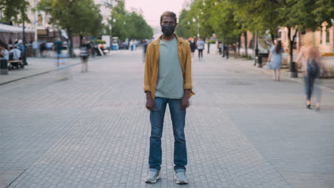 man wearing a mask in a city street