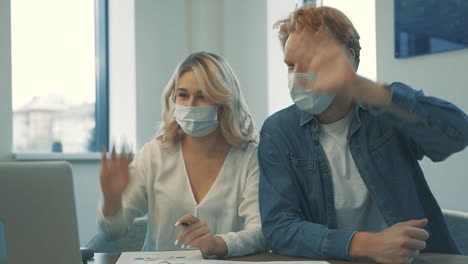 Young-Woman-And-Man-With-Face-Mask-Having-A-Business-Video-Call