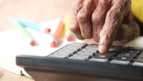elderly person using a calculator