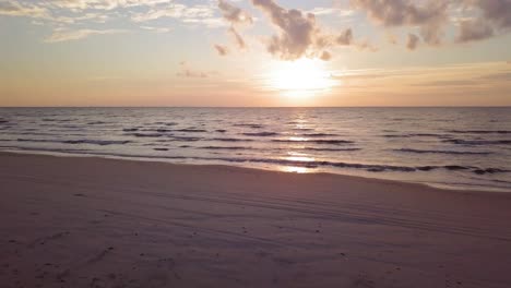 beautiful aerial establishing view of baltic sea coast on a sunny evening, sunset, golden hour, beach with white sand, coastal erosion, climate changes, wide angle drone shot moving forward