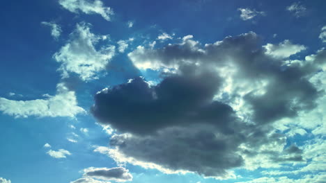 sunlight behind cumulus fluffy clouds during sunrise