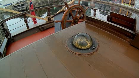 zooming shot of pirate ship compass on deck