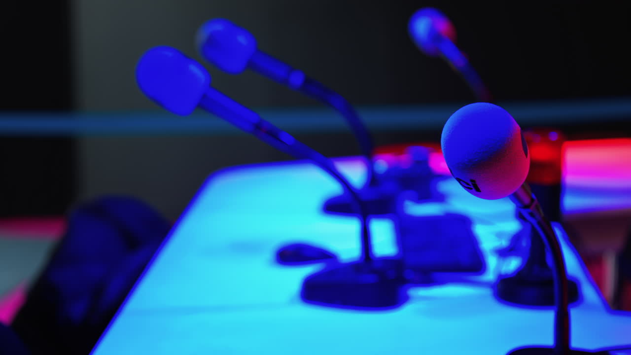 Cannes, France - March 2, 2025: Close up of a microphone on a blurred background with blue and red lights at the International Games Festival