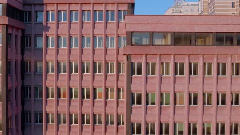 Aerial-riser-next-to-building-reveals-historic-port-city-of-Genoa,-Italy