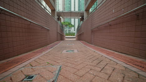 Dolly-forward-shot-of-square-in-front-of-high-skyscraper-buildings-in-Hong-Kong-City