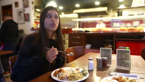 woman eating a delicious meal in a restaurant