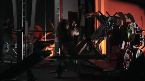 a woman dances beautifully in the dark corridor of the fitness center. a sexy woman in lingerie dances in the gym.