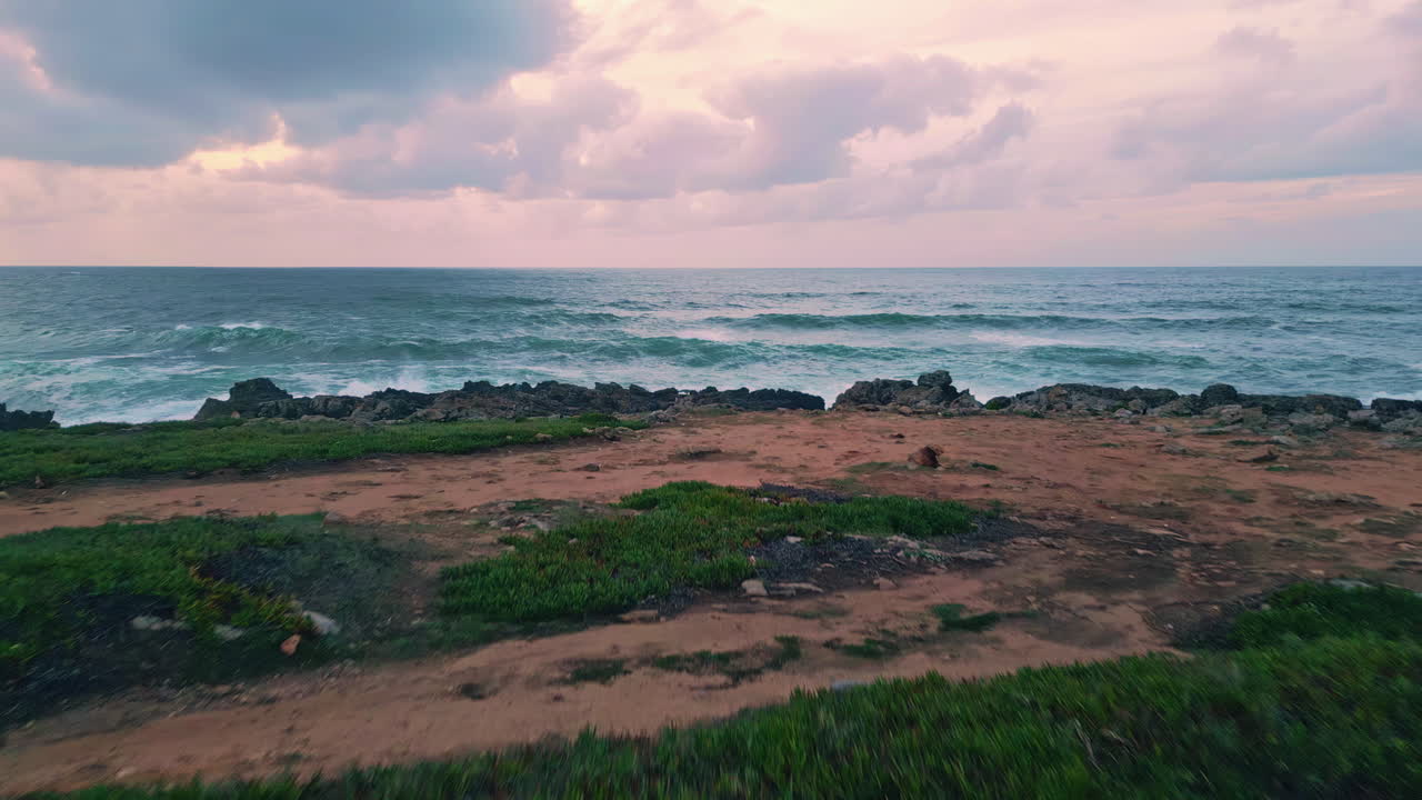 Foamy swell crashing coastline under gloomy sky drone view. terrain