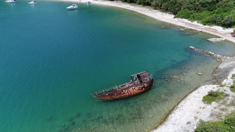 Discover-the-picturesque-coastal-scenery-of-Rakalj-Pula-Sea-in-Croatia-with-scenic-aerial-footage,-showcases-the-natural-blue-water-bay-beach-coast,-surrounded-by-sunken-ship