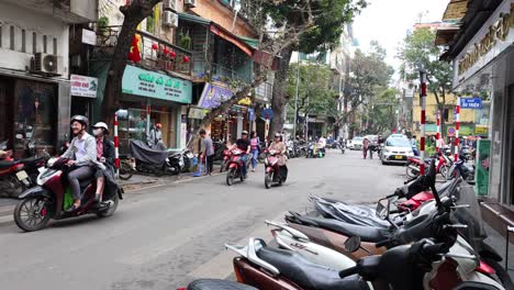 motorbikes and pedestrians on a bustling hanoi street