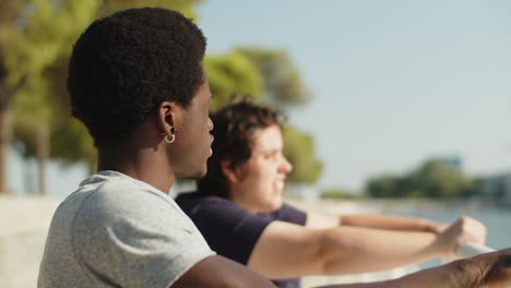 African-American-man-sitting-at-quayside-with-female-friend