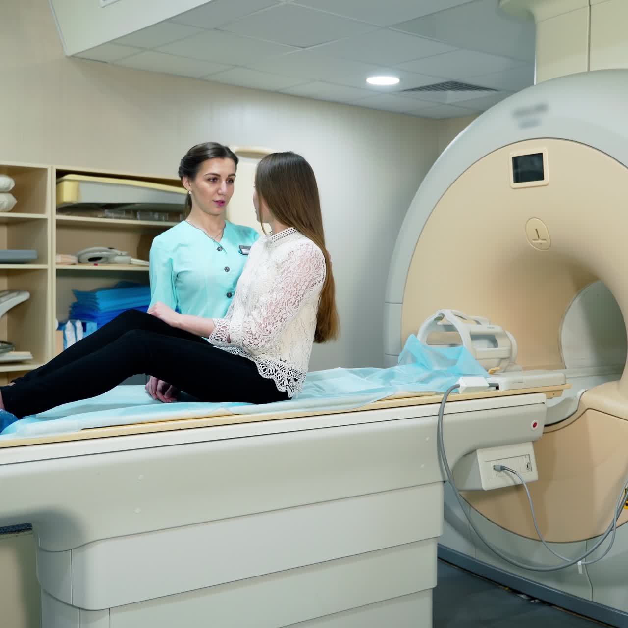 Young woman doing mri procedure in modern clinic. Female patient lying on a medical table machine before tomography examination. Contemporary equipment in medicine.