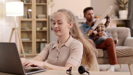 woman working and family playing