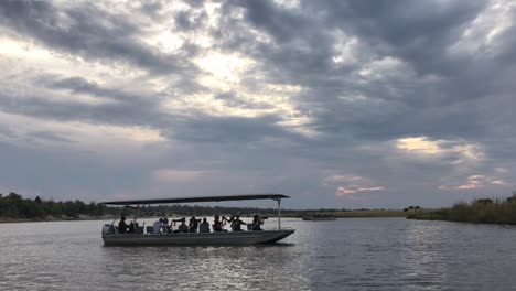 photo safari tour boats on chobe river under dramatic african sky